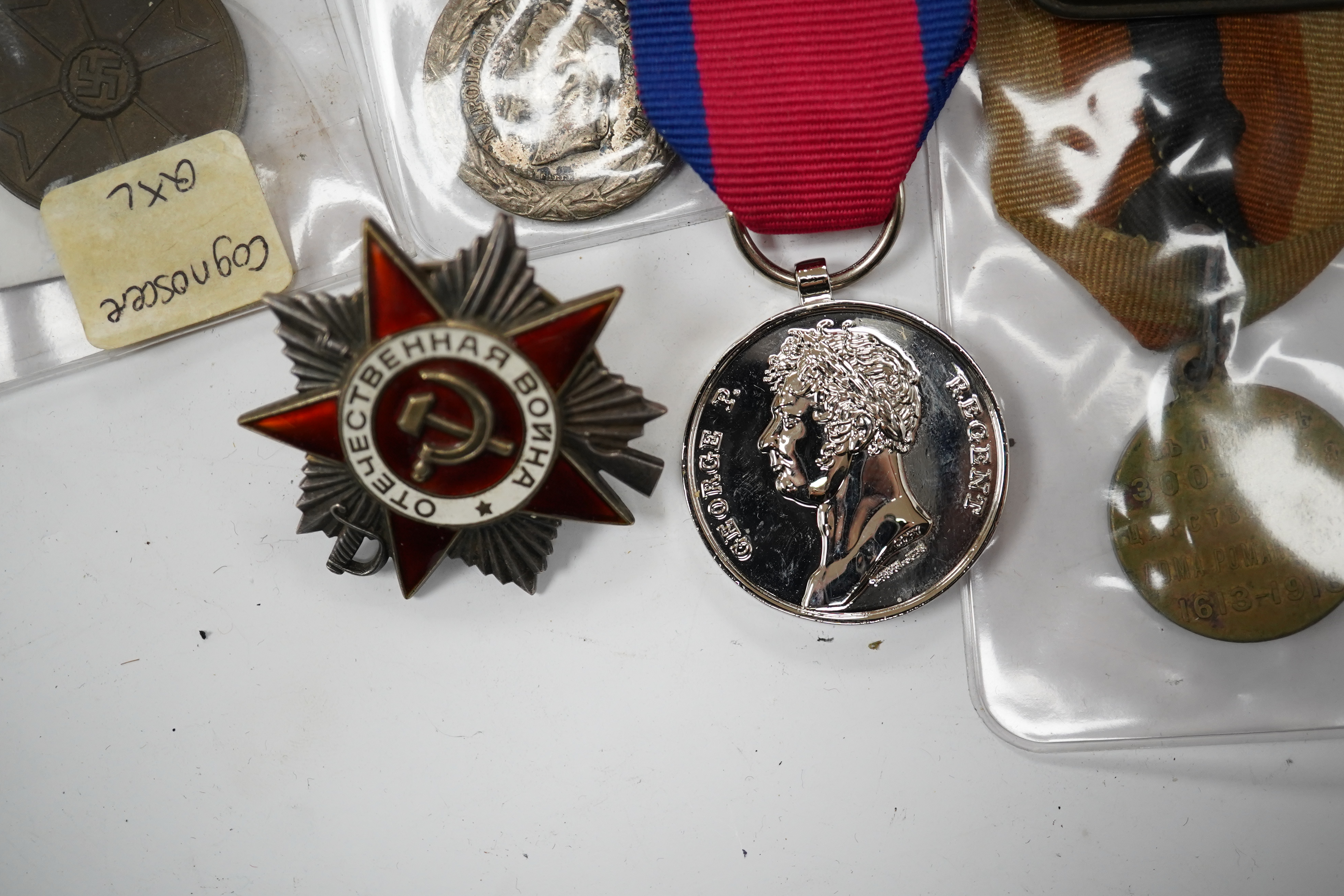 Fifteen British, German, etc. military medals including; a First World War medal pair to DVR. A.E. Hooker. R.A., a boxed WWII Defence Medal, a 1914 Second Class Iron Cross, a France Italian Campaign medal, a 1939 German